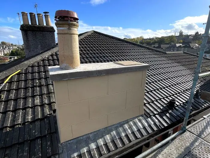 The same chimney stack rebuilt with new coping stone and render