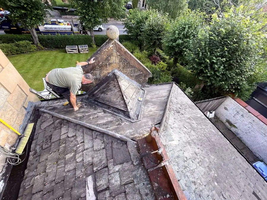 Jaconelli Builders tradesman working on a chimney at roof height