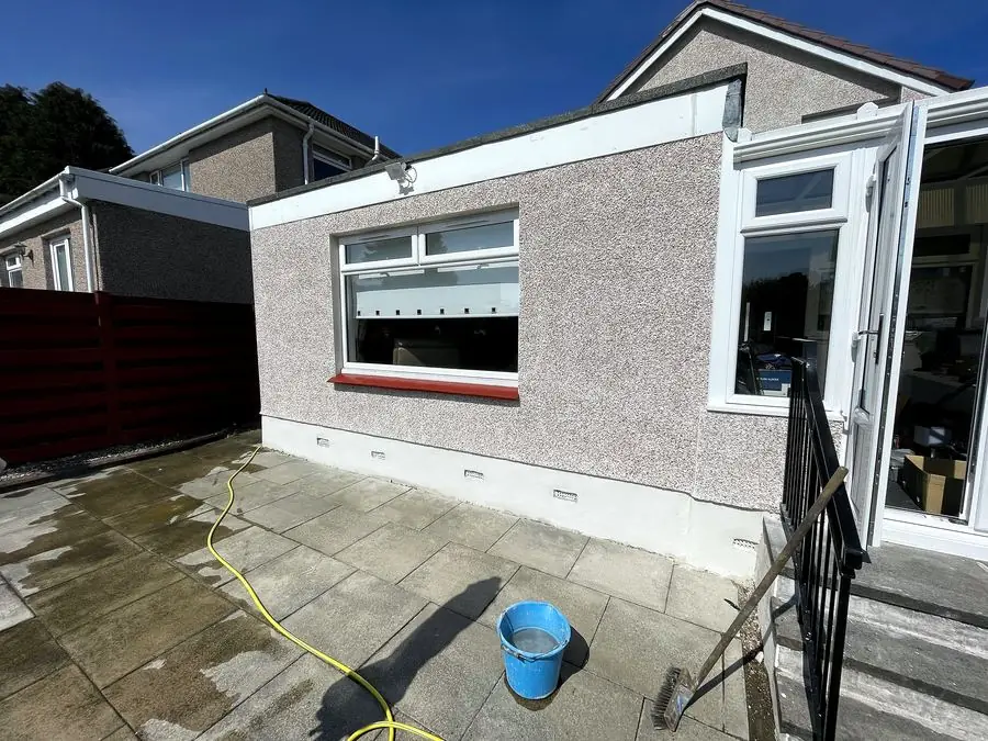Rendered single-storey extension with new windows