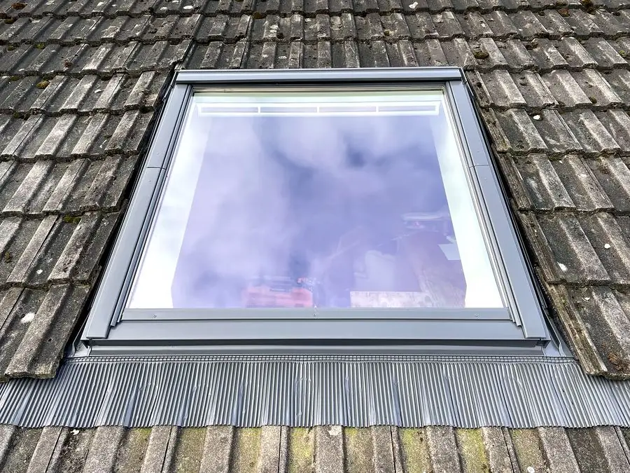 Velux rooflight installed with new flashing in a tiled roof